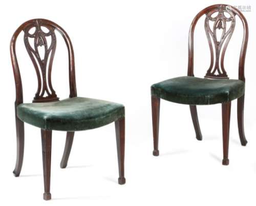 A pair of George III mahogany side chairs, each with an arched back, with a pierced splat carved