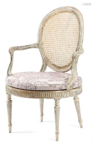 A George III white painted open armchair, with a moulded frame and a caned back and seat, with a