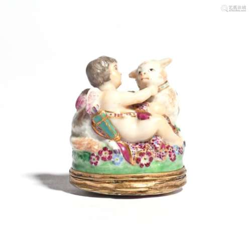 A Chelsea bonbonnière c.1765, modelled as Cupid seated on a flowered grassy base with a lamb wearing