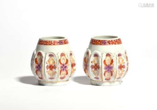 A small pair of Meissen hausmaler pots or vases c.1725, the rounded shapes moulded with a continuous