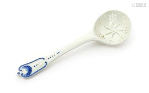 A Chantilly porcelain sugar ladle mid 18th century, the deep circular bowl pierced with seven