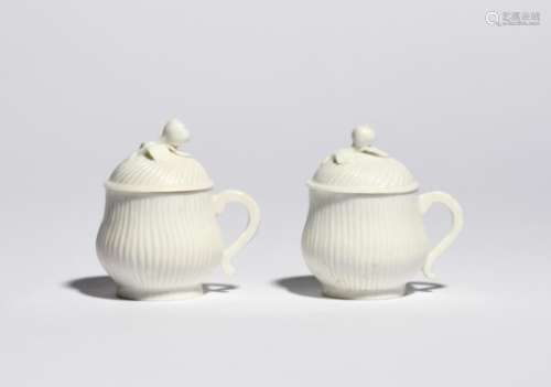 Two Mennecy custard cups and covers c.1760, the rounded bodies with spiral moulding, applied with