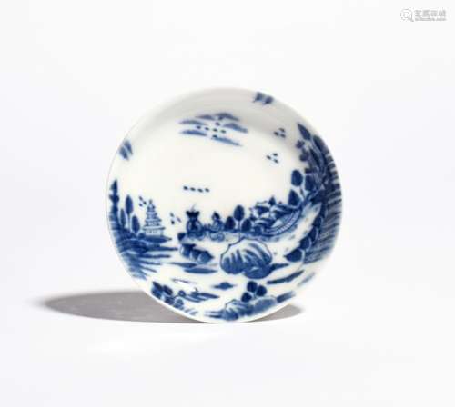 A Meissen saucer c.1730-40, painted in underglaze blue with two Oriental figures seated before low