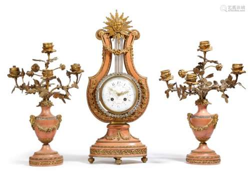 A late 19th century French pink marble and ormolu clock garniture in Louis XVI style, the lyre shape