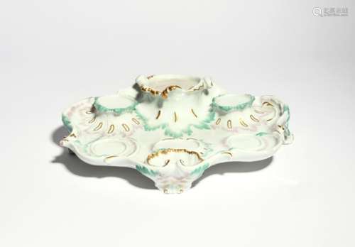 A Meissen surtout de table or stand 19th century, of rococo scrolling form, raised on three scroll