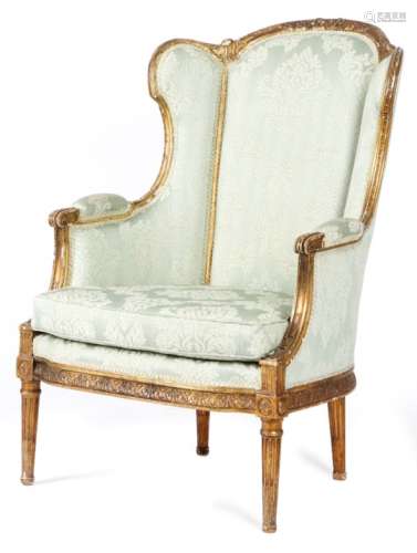 A late 19th century French giltwood bergθre in Louis XVI style, the moulded frame carved with