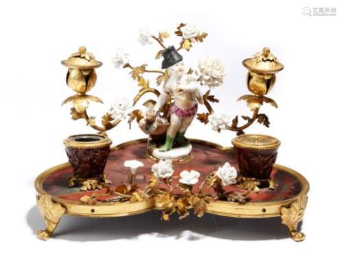An ormolu and porcelain mounted encrier in Louis XV style, with an oriental lacquered base, with a