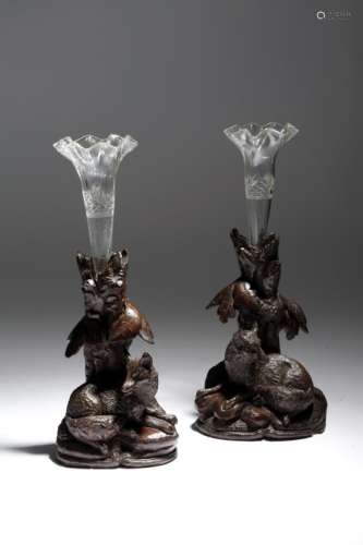 A near pair of late 19th century Black Forest carved wood epergnes, each with a glass vase, inset