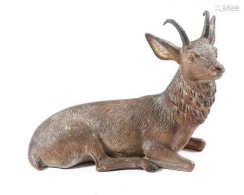 A late 19th century German painted terracotta model of a recumbent stag, 25.5cm wide.
