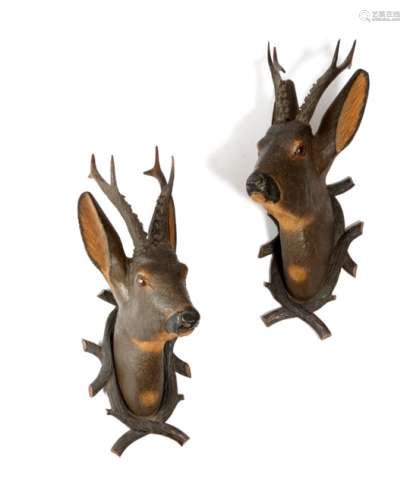 A pair of late 19th century Black Forest carved and painted wood roe deer trophy mounts, with