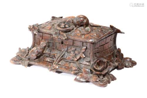 A late 19th century Black Forest carved wood box, of naturalistic form decorated with two rats, with