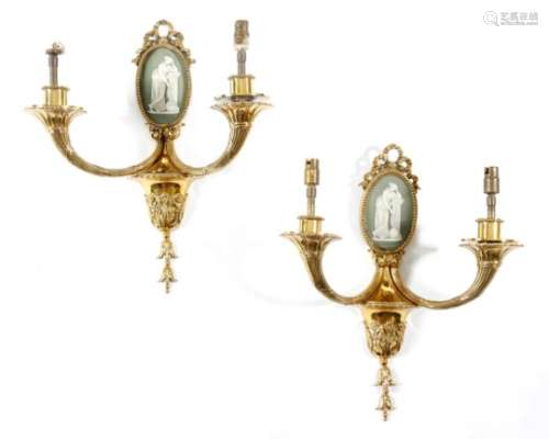 A pair of Victorian gilt brass wall lights, each with a ribbon tied backplate with an oval