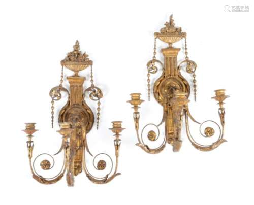 A pair of 19th century giltwood and composition three-light wall sconces in Adam style, each with an