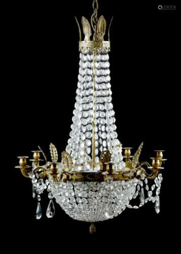 A brass and cut-glass eight-light chandelier in Empire style, the leaf decorated corona applied with