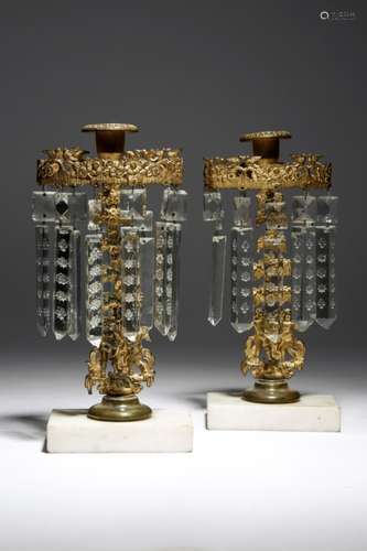 A pair of Regency gilt bronze and lustre candlesticks, each with a bird and flower corona hung