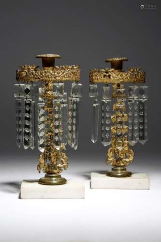 A pair of Regency gilt bronze and lustre candlesticks, each with a bird and flower corona hung