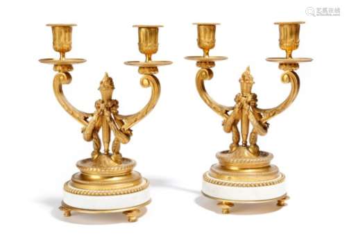 A pair of late 19th century French ormolu and white marble twin-light candelabra in Louis XVI style,