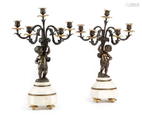 A pair of late 19th century French gilt and patinated bronze figural candelabra, each with a