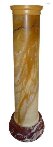 A pair of Siena marble columns, each with a later painted wood top, on a red marble plinth base,