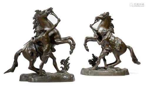 After Guillaume Coustou (French 1677-1746). A pair of bronze Marly horse groups, the naturalistic