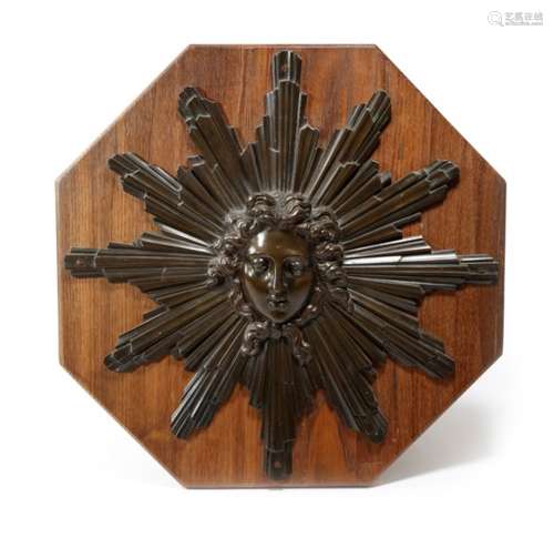 A 19th century French bronze Apollo sunburst relief, in Louis XIV style, mounted on a later wooden