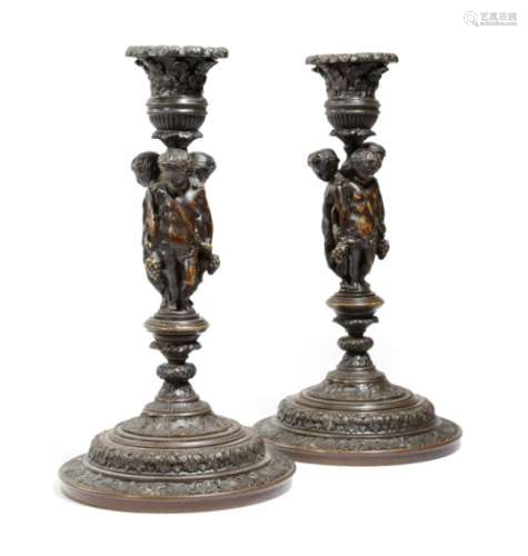 A pair of late 19th century French Renaissance revival candlesticks, the stems with three