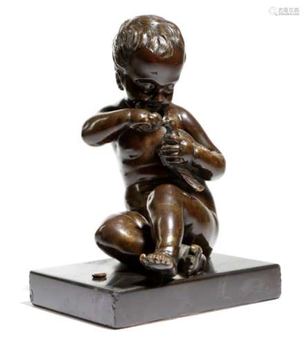 A French bronze model of a seated cherub, holding a bird, mounted on a black marble base, probably