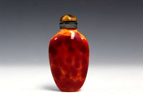 Chinese yellow and red glass snuff bottle.