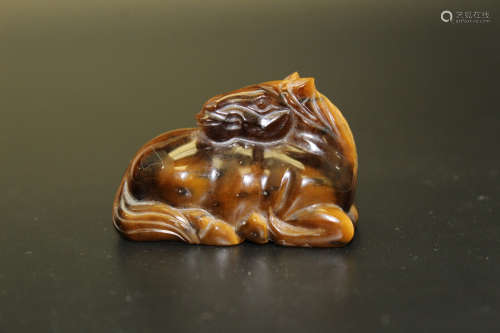 A Chinese carved tiger's eye stone horse figurine.