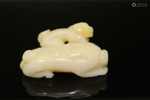 Chinese carved yellow jade toggle of two dogs.