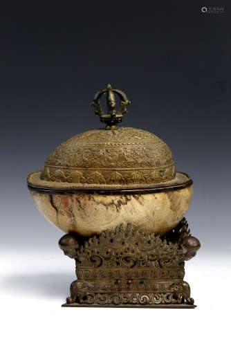 Tibetan gilt metal mounted skull ritual vessel.