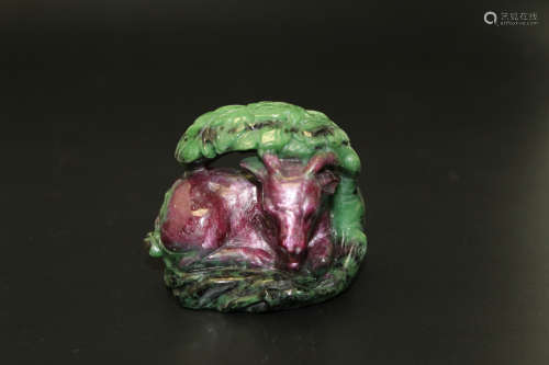 Chinese carved Ruby-zoisite goat under a tree.