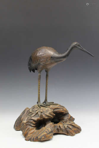 Japanese bronze figure of a crane on wood stand.