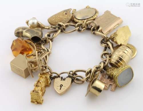 9ct charm bracelet with a good variety of charms attached, total weight 64.3g