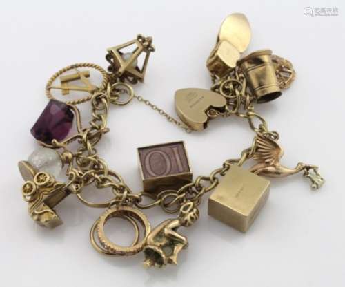9ct Charm bracelet with a good assortment of charms attached. total weight 48.2g