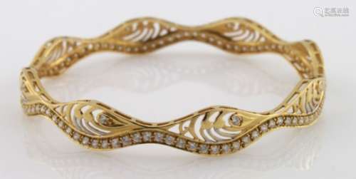 High carat (tests as approx 20ct) yellow gold wavy slave bangle set with cubic zirconia, 15.2g