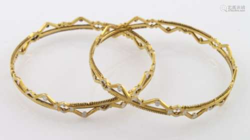 Set of two high carat (tests as approx 22ct) yellow and white gold slave bangles, weight 30.9g