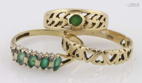 Three 9ct yellow gold rings, one heart band and two emerald set (with a stone missing) weight 5.5g