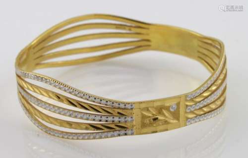 High carat (tests as approx 22ct) two colour wave design slave bangle, weight 33.6g