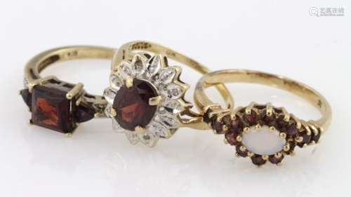 Three 9ct garnet gem set rings, weight 7.6g