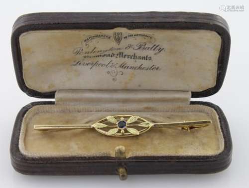 18ct bar brooch with a small sapphire, approx 2g in its original ? box