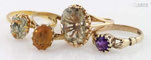 Four 9ct gold gem set solitaire rings to include citrine, smoky quartz, amethyst and moss agate,