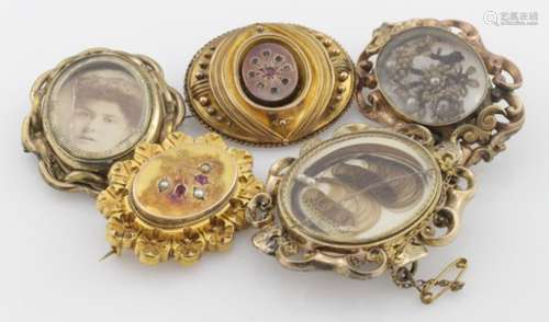 Five 9ct / Yellow metal mourning brooches with four having locks of hair encased.