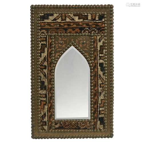 A Moroccan style brass and wood mirror with carpet