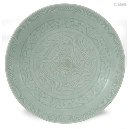 A Chinese celadon-glazed incised dish, with carved wood