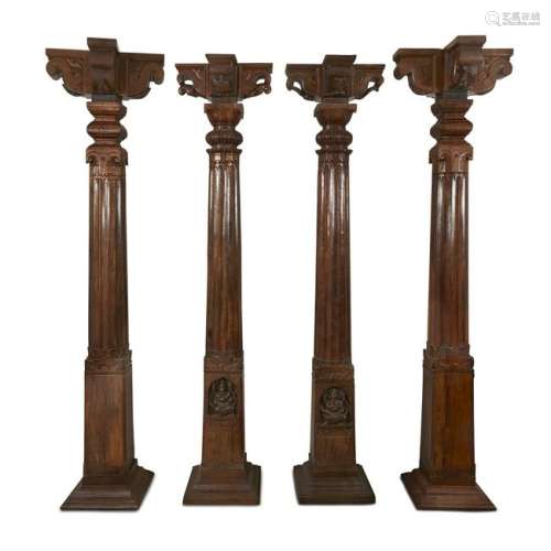 A set of four associated Indian carved teak columns,