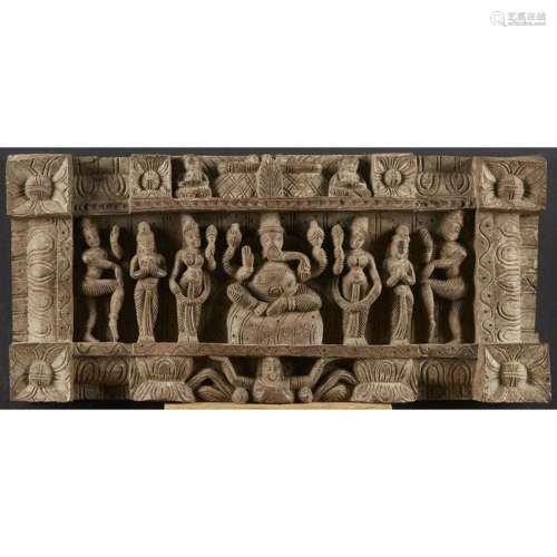A carved Indian wood relief depicting Ganesh and