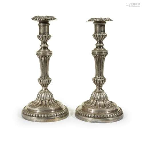A pair of Louis XVI silvered bronze candlesticks, late