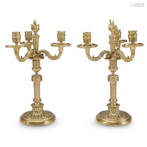 A pair of Louis XVI style gilt-brass three-light