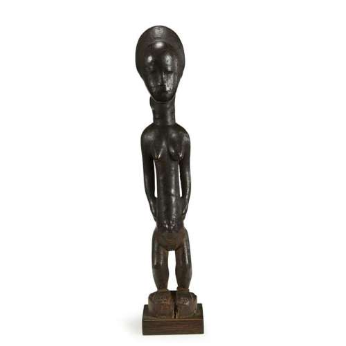 A Baule carved wood standing female figure Delicately